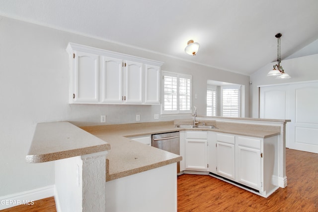 kitchen with stainless steel dishwasher, a peninsula, white cabinetry, and a sink