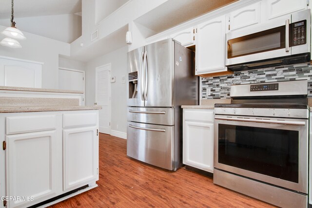 kitchen featuring tasteful backsplash, light countertops, white cabinets, visible vents, and appliances with stainless steel finishes