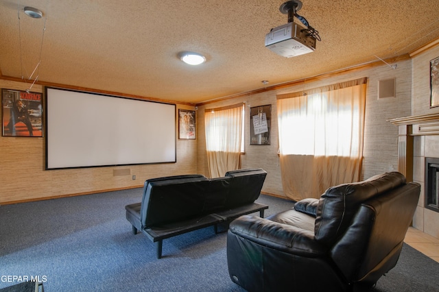carpeted cinema with a tiled fireplace and a textured ceiling