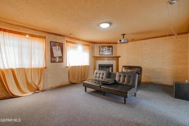 sitting room with carpet, a tile fireplace, and a textured ceiling