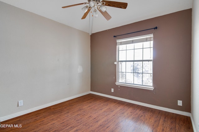 unfurnished room with baseboards, a ceiling fan, and wood finished floors