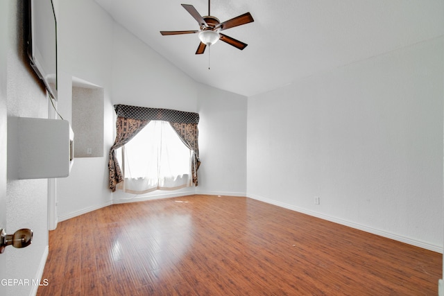 unfurnished living room with high vaulted ceiling, baseboards, wood finished floors, and ceiling fan