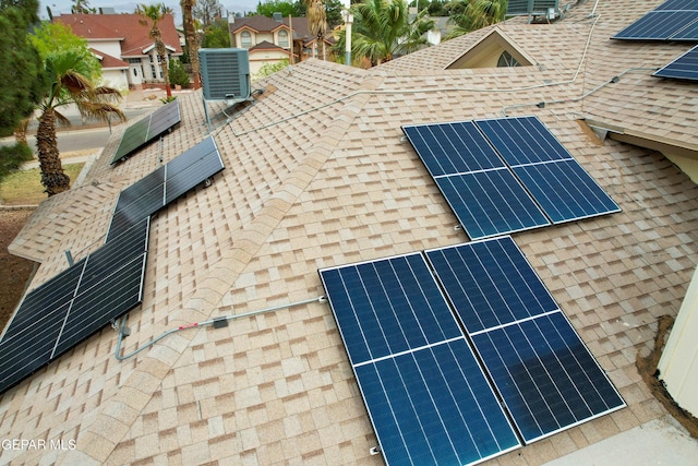 exterior details with a shingled roof and cooling unit
