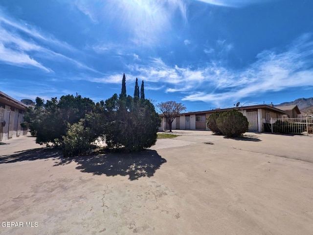 exterior space with concrete driveway and fence