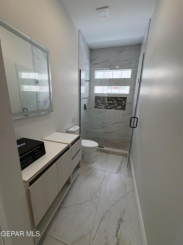 11345 Ardelle Ave, El Paso, TX 79936 - full bathroom featuring vanity, toilet, marble finish floor, a marble finish shower, and baseboards
