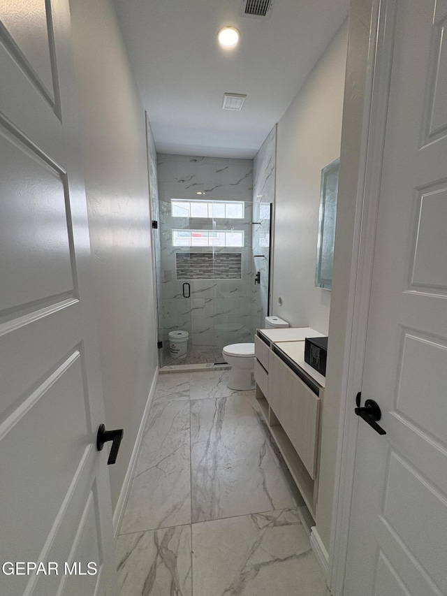 11345 Ardelle Ave, El Paso, TX 79936 - bathroom with vanity, baseboards, toilet, a marble finish shower, and marble finish floor