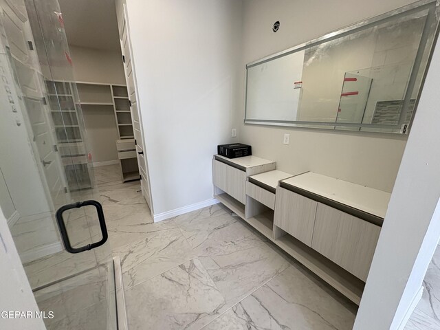 11345 Ardelle Ave, El Paso, TX 79936 - bathroom featuring marble finish floor, baseboards, and vanity
