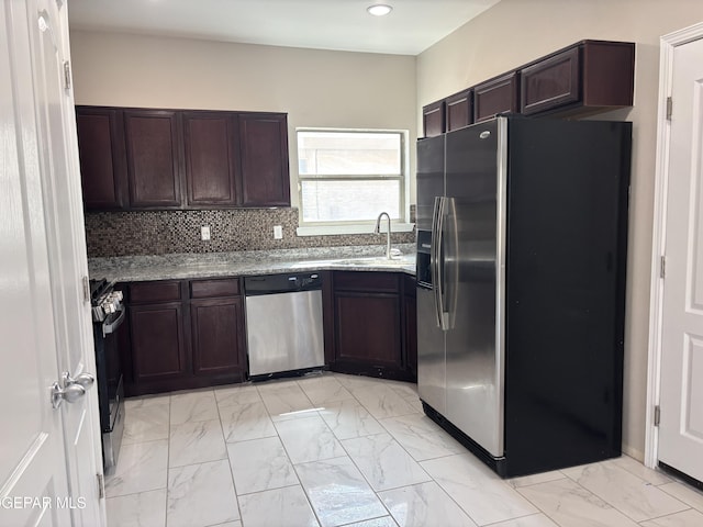 kitchen with dark brown cabinets, light stone countertops, stainless steel appliances, and marble finish floor