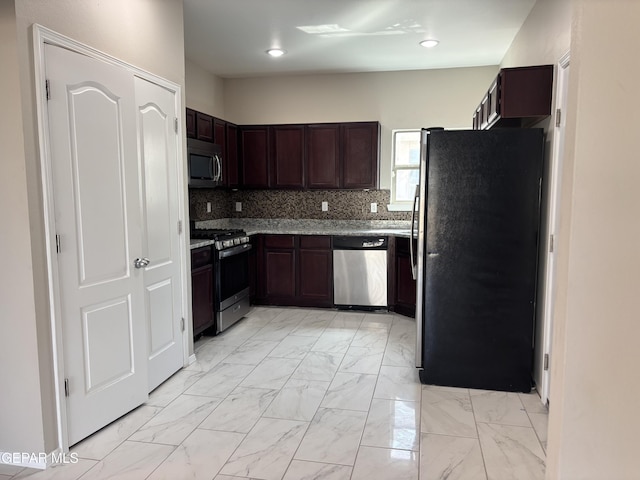 kitchen featuring tasteful backsplash, light stone countertops, dark brown cabinets, marble finish floor, and stainless steel appliances