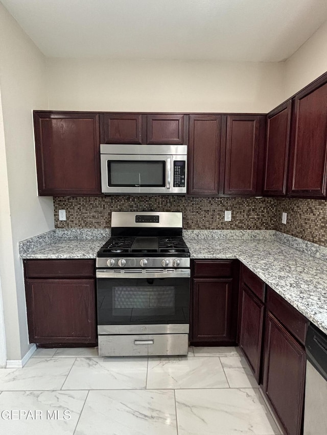 kitchen with baseboards, marble finish floor, tasteful backsplash, and stainless steel appliances
