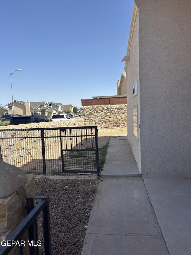 view of yard featuring a residential view and fence