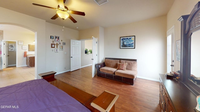 7350 La Casa Way, Canutillo, TX 79835 - bedroom with visible vents, baseboards, light wood-type flooring, connected bathroom, and arched walkways