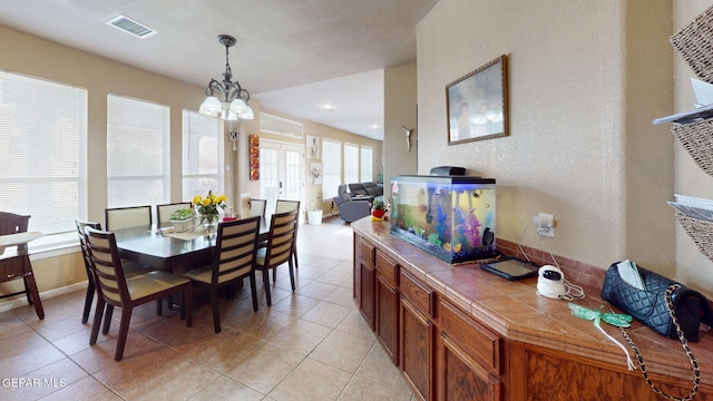 7350 La Casa Way, Canutillo, TX 79835 - dining area featuring light tile patterned floors, visible vents, and a notable chandelier