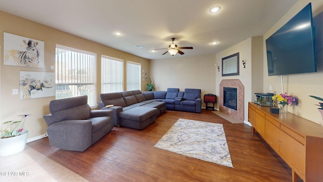 7350 La Casa Way, Canutillo, TX 79835 - living room with a ceiling fan, recessed lighting, a tiled fireplace, and wood finished floors