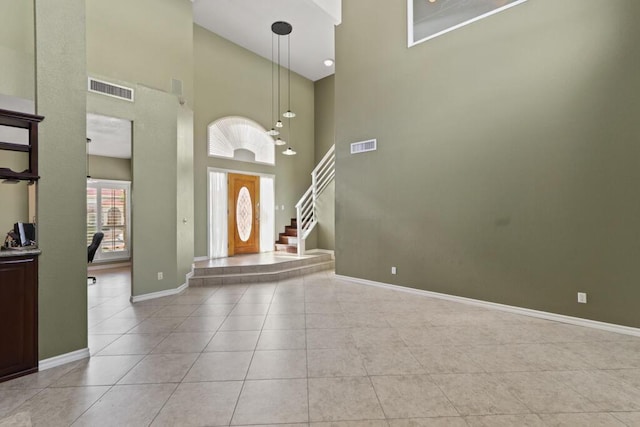 5628 Buckley Dr, El Paso, TX 79912 - foyer entrance featuring a towering ceiling, baseboards, visible vents, and light tile patterned flooring