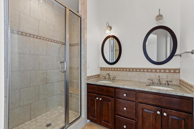 5628 Buckley Dr, El Paso, TX 79912 - full bathroom featuring a shower stall, double vanity, and a sink