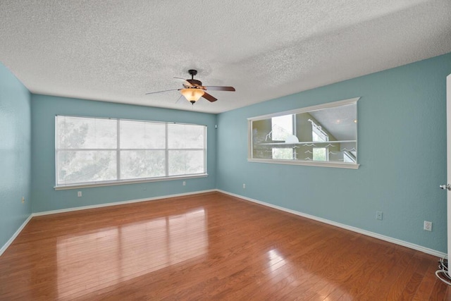 5628 Buckley Dr, El Paso, TX 79912 - spare room featuring plenty of natural light, a textured ceiling, wood finished floors, and ceiling fan