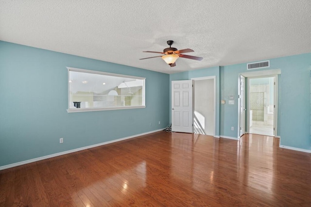 5628 Buckley Dr, El Paso, TX 79912 - unfurnished bedroom with a textured ceiling, wood finished floors, multiple windows, and visible vents