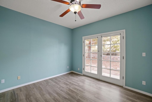 5628 Buckley Dr, El Paso, TX 79912 - empty room featuring french doors, baseboards, and wood finished floors