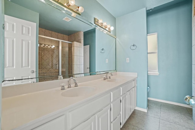 5628 Buckley Dr, El Paso, TX 79912 - bathroom featuring tile patterned floors, double vanity, a sink, and a stall shower