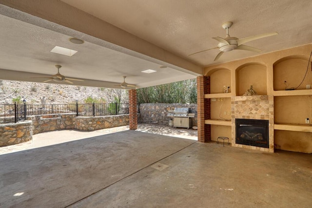 5628 Buckley Dr, El Paso, TX 79912 - view of patio / terrace featuring a tiled fireplace, grilling area, fence, and a ceiling fan