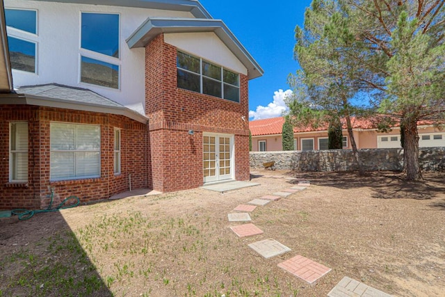 5628 Buckley Dr, El Paso, TX 79912 - back of house with french doors, stucco siding, and brick siding