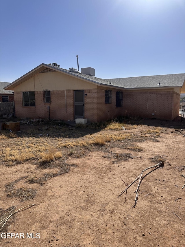 rear view of house featuring brick siding