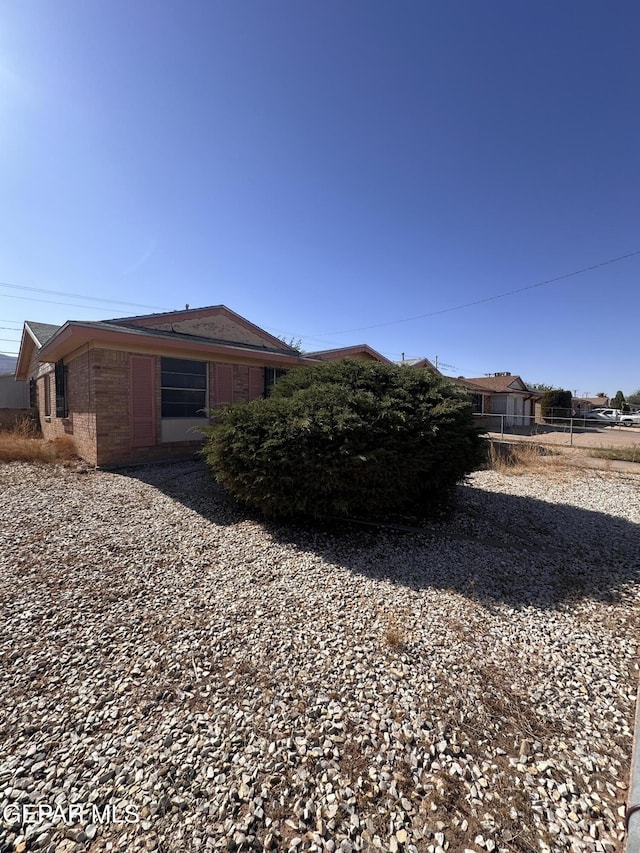 view of side of home with fence