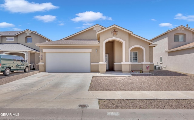 3841 Loma Adriana, El Paso, TX 79938 - mediterranean / spanish-style house featuring stucco siding, a garage, and concrete driveway