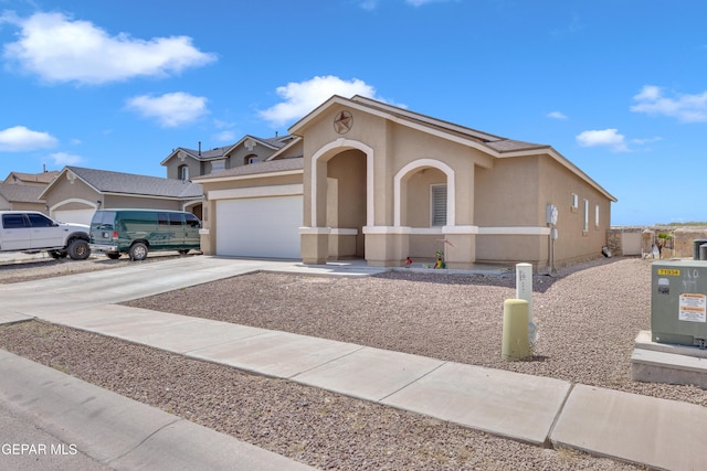 3841 Loma Adriana, El Paso, TX 79938 - view of front of house featuring an attached garage, stucco siding, and driveway