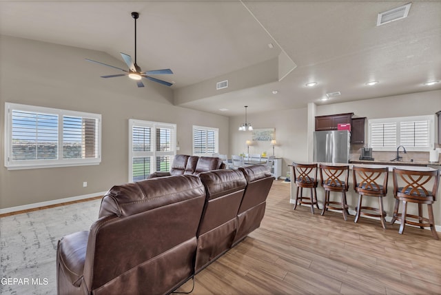 3841 Loma Adriana, El Paso, TX 79938 - living area with a ceiling fan, light wood-style flooring, healthy amount of natural light, vaulted ceiling, and baseboards