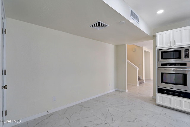 kitchen with baseboards, visible vents, marble finish floor, and appliances with stainless steel finishes