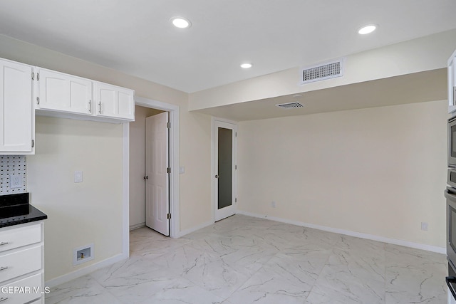 kitchen featuring baseboards, visible vents, recessed lighting, and white cabinetry