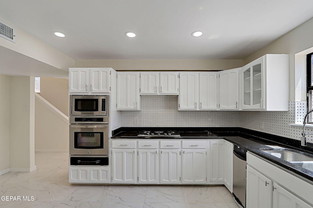 kitchen with white cabinetry, marble finish floor, stainless steel appliances, and a sink