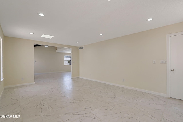 spare room featuring baseboards, visible vents, recessed lighting, and marble finish floor