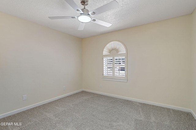 carpeted spare room with baseboards, a textured ceiling, and ceiling fan