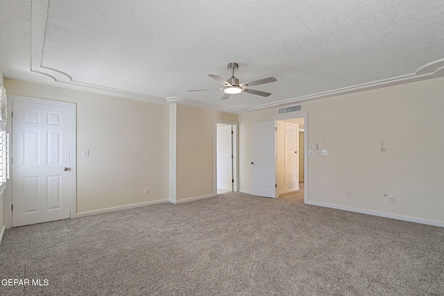 empty room with a ceiling fan, a textured ceiling, carpet floors, baseboards, and visible vents