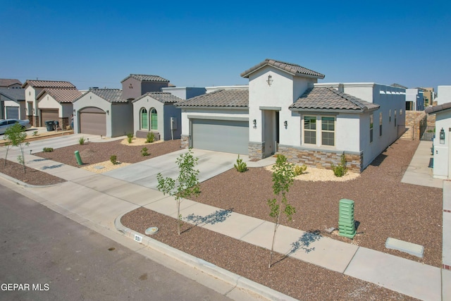 951 Airship Pl, El Paso, TX 79928 - mediterranean / spanish home with stucco siding, a tiled roof, an attached garage, and stone siding