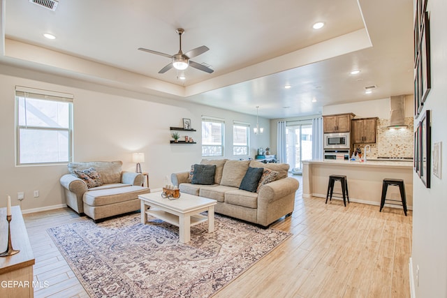 951 Airship Pl, El Paso, TX 79928 - living room with a ceiling fan, light wood-style floors, a tray ceiling, recessed lighting, and baseboards