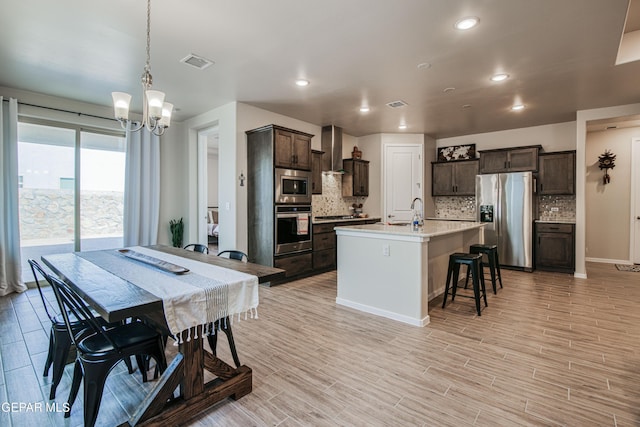 951 Airship Pl, El Paso, TX 79928 - kitchen with appliances with stainless steel finishes, a chandelier, dark brown cabinetry, tasteful backsplash, and recessed lighting
