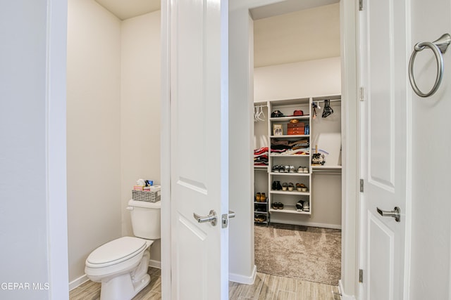 951 Airship Pl, El Paso, TX 79928 - bathroom featuring wood tiled floors, toilet, a spacious closet, and baseboards