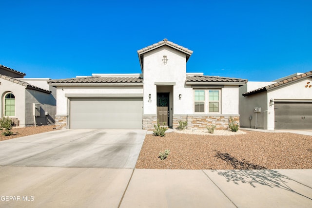 951 Airship Pl, El Paso, TX 79928 - mediterranean / spanish home featuring stone siding, stucco siding, a garage, and driveway