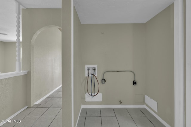 clothes washing area with gas dryer hookup, tile patterned floors, hookup for a washing machine, and laundry area
