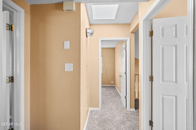 hall with carpet floors and baseboards