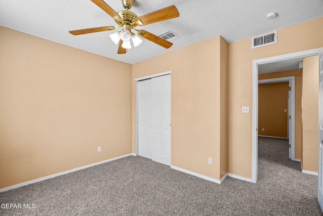 unfurnished bedroom featuring a closet, visible vents, and carpet flooring