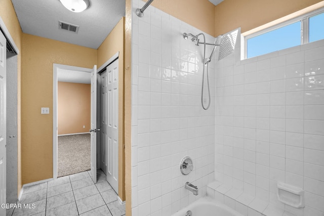 full bath featuring shower / washtub combination, tile patterned floors, and visible vents