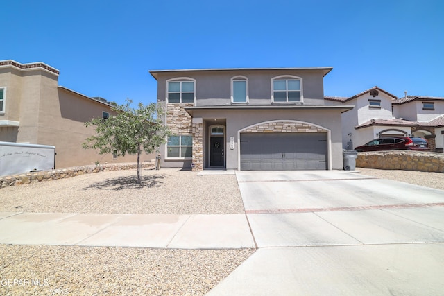 7825 Enchanted Ridge Dr, El Paso, TX 79911 - mediterranean / spanish house featuring concrete driveway, stone siding, a garage, and stucco siding