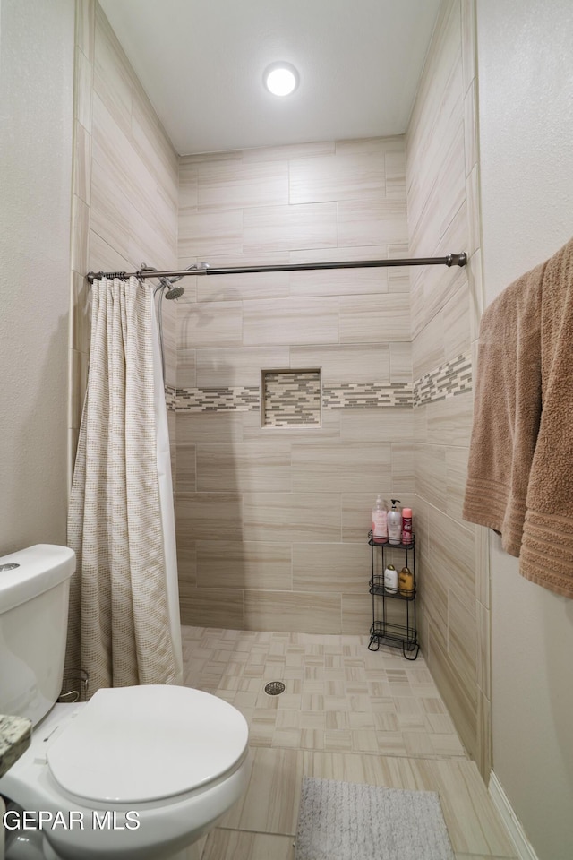 7825 Enchanted Ridge Dr, El Paso, TX 79911 - full bath featuring a tile shower and toilet