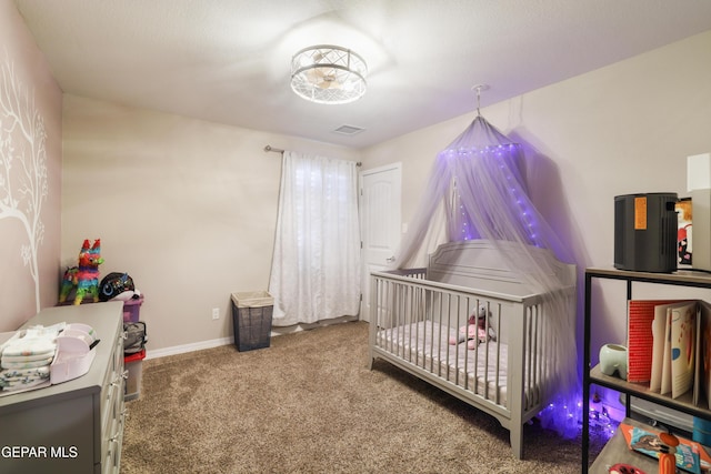 7825 Enchanted Ridge Dr, El Paso, TX 79911 - bedroom featuring baseboards, carpet flooring, a crib, and visible vents