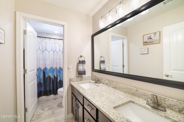 7825 Enchanted Ridge Dr, El Paso, TX 79911 - bathroom with toilet, visible vents, a sink, and double vanity